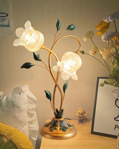 Photo par Shoowz Lampe de table en forme de fleurs avec abat-jour en verre et tige dorée, posée sur une table de chevet, image Pinterest