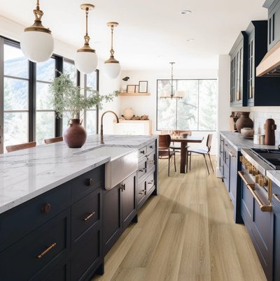 Plancher vinyle Laurel Reserve Cabana au fini mat installé dans une cuisine moderne avec armoires bleu marine et comptoirs en marbre chez Plancher 2000