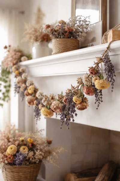 Guirlande de fleurs séchées aux tons naturels décorant le manteau d'un foyer blanc, dans une ambiance champêtre Source - My Garbage Collection Pinterest