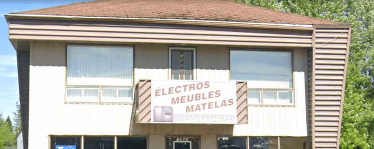 Façade du commerce Ameublements Guy Malo Inc. avec une enseigne indiquant Électros, Meubles, Matelas et un numéro de téléphone.