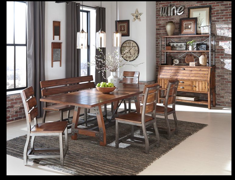 Salle à manger style industriel rustique avec mobilier en bois et métal de chez Meubles Casa Salle à manger au design industriel rustique avec une table en bois massif et pieds métalliques, des chaises assorties, un banc en bois, un buffet vintage et une décoration murale chaleureuse en briques apparentes de chez Meubles Casa